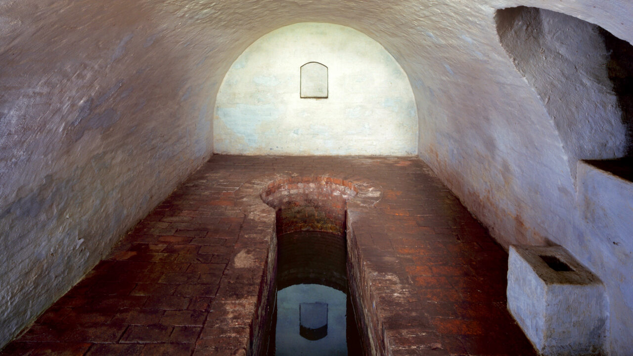 Mikwe Wörlitz: Wasser in der Mikwe in einem runden geweißelten Kellerraum